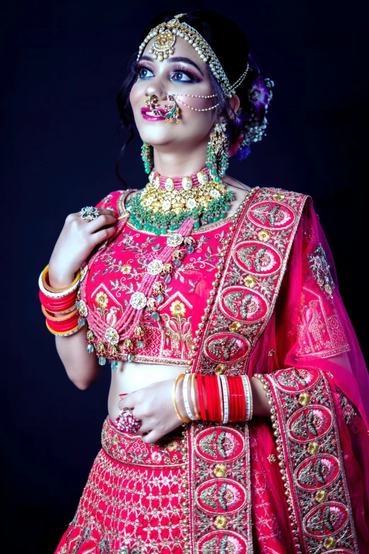 woman wearing bright pink and gold outfit with jewelry