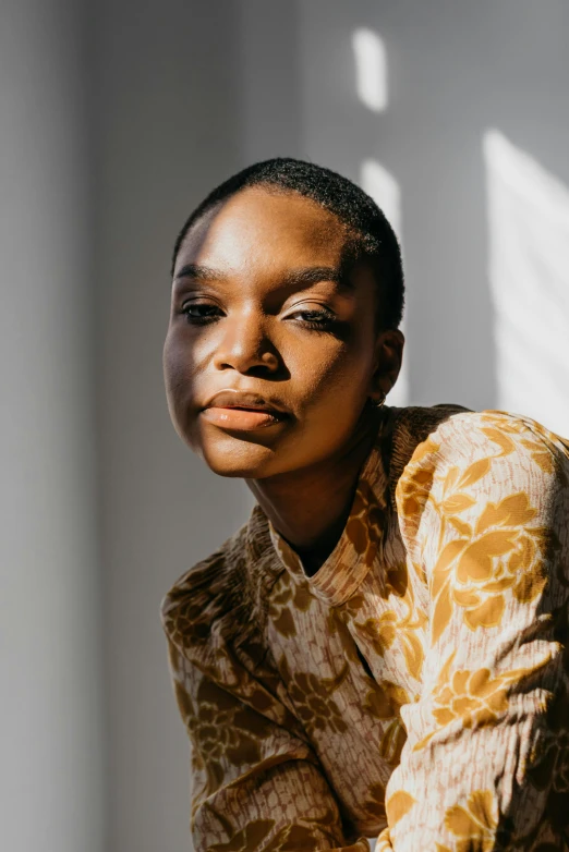 a woman sitting wearing an animal print shirt