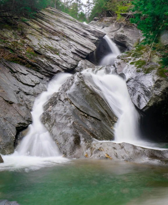 water flowing over rocks next to a river