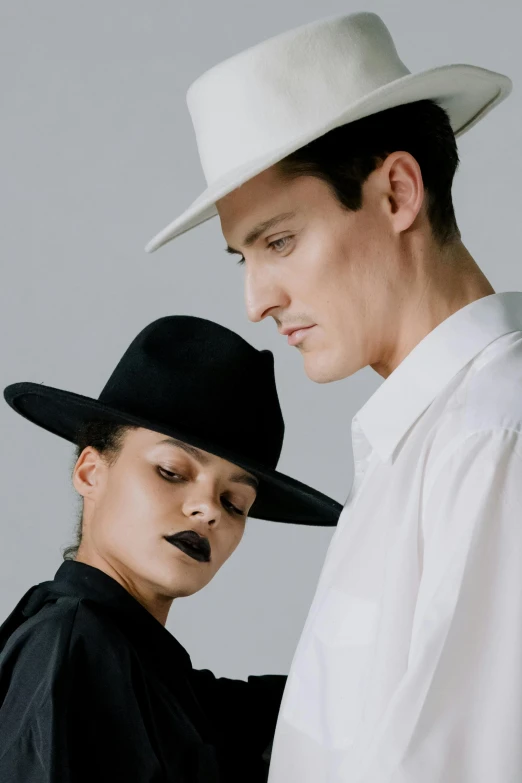 a man in white and woman with black makeup