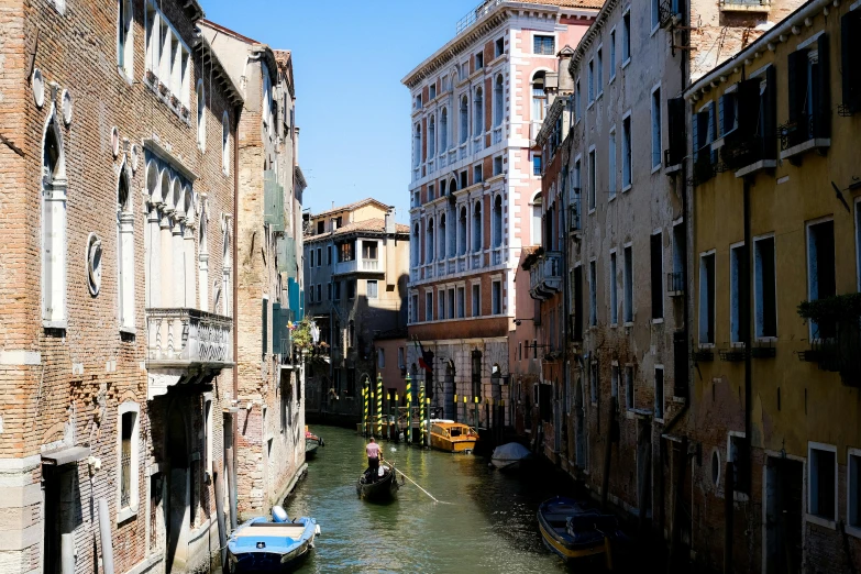 a small river with houses and boats on the side of it