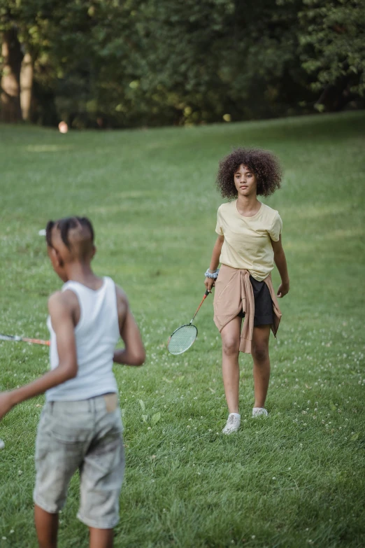 two people that are playing in the grass