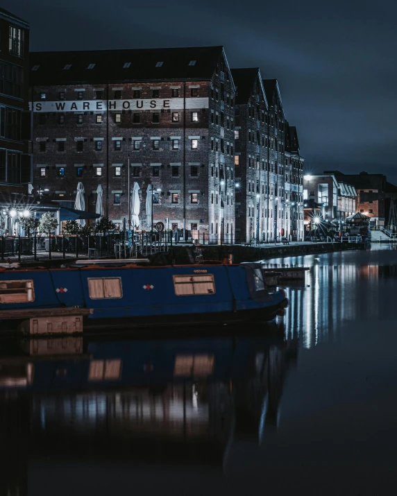 a nighttime view of the canal in front of an urban building