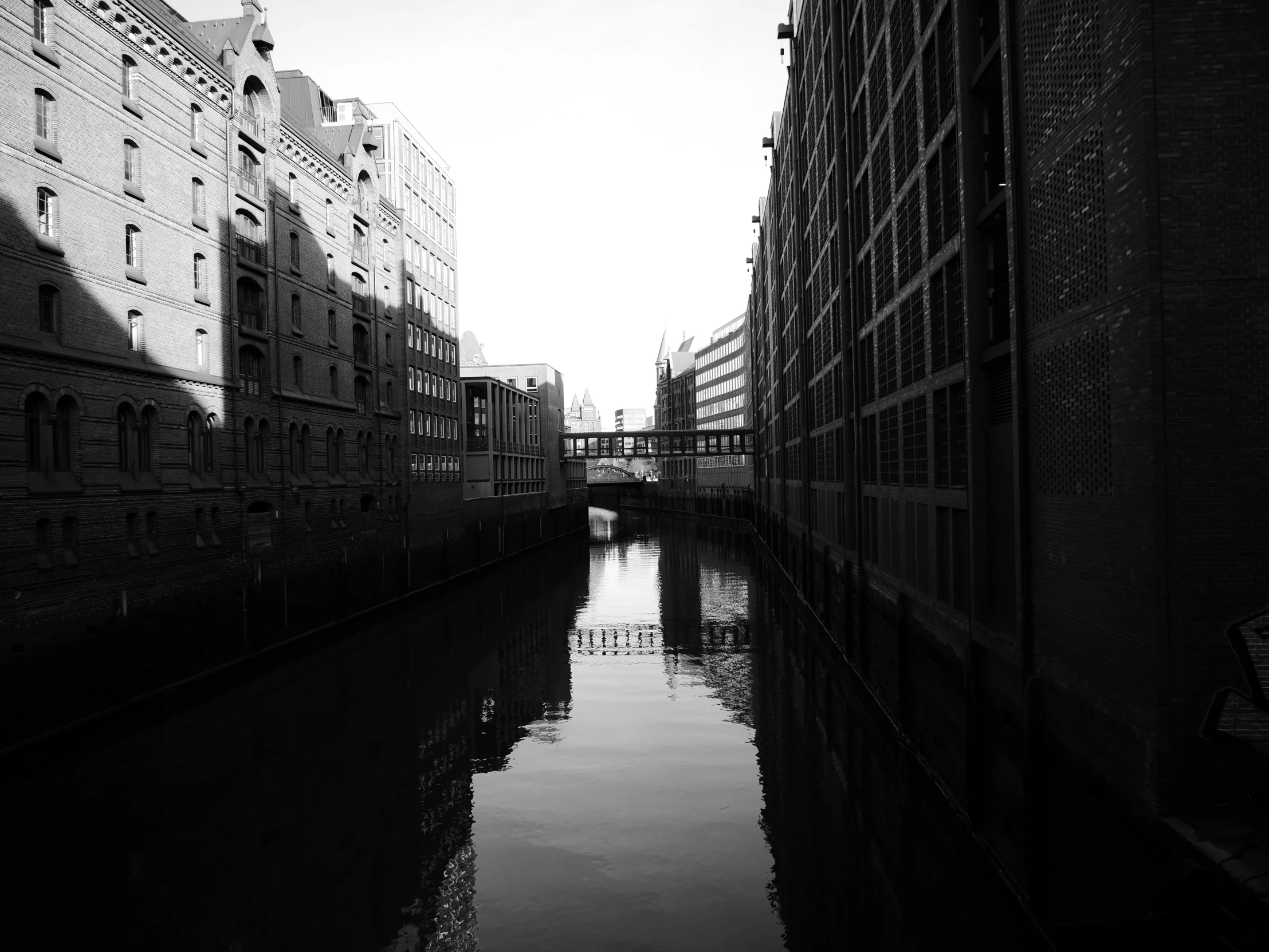 a body of water next to brick buildings