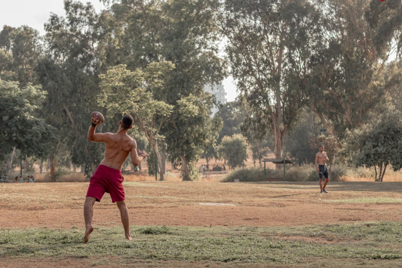 the man in red shorts is throwing a frisbee