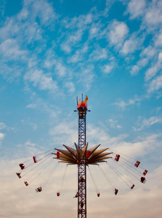 a carnival ride surrounded by sky during the day