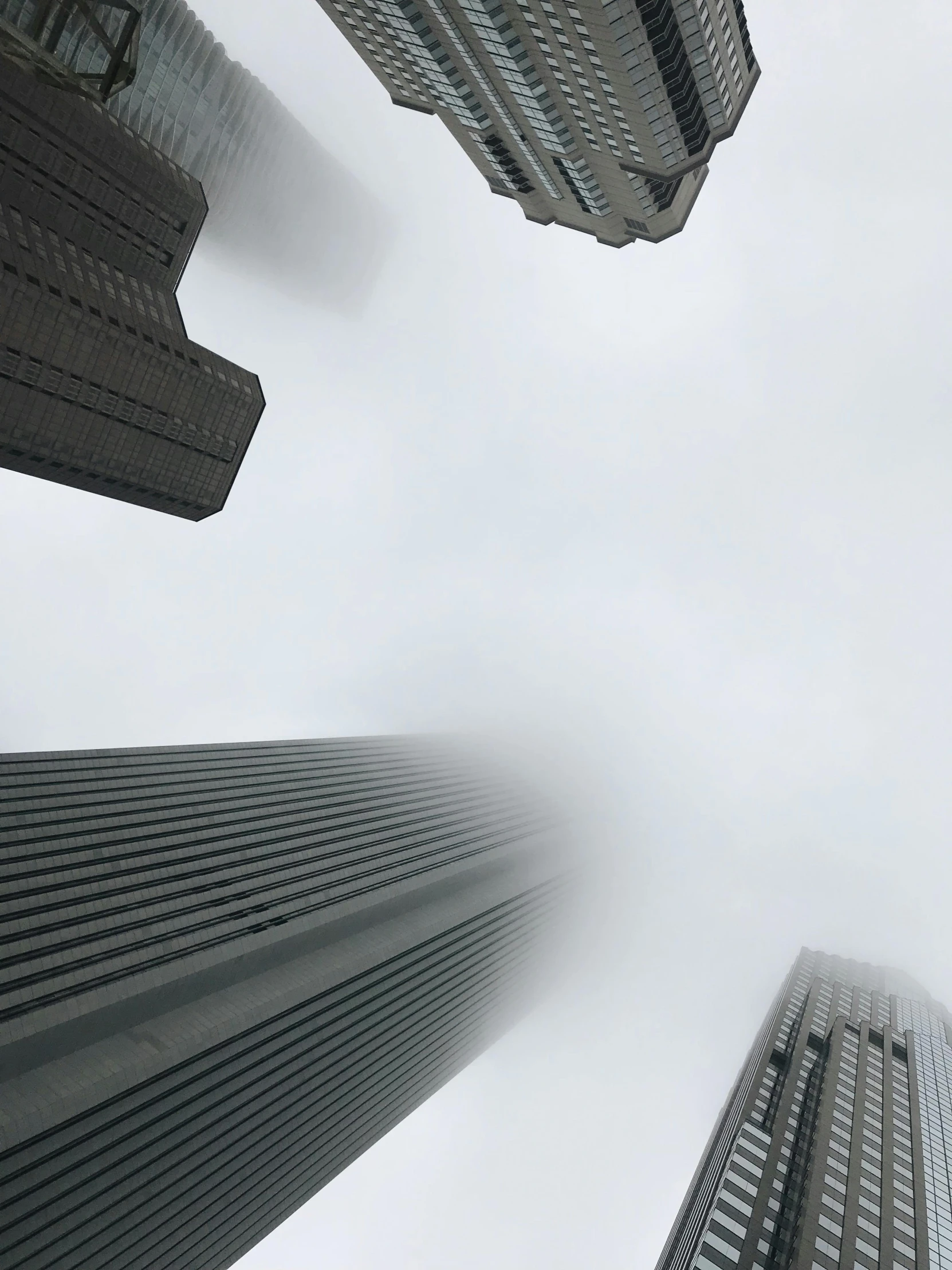 three high rise buildings rise in the air with an odd look