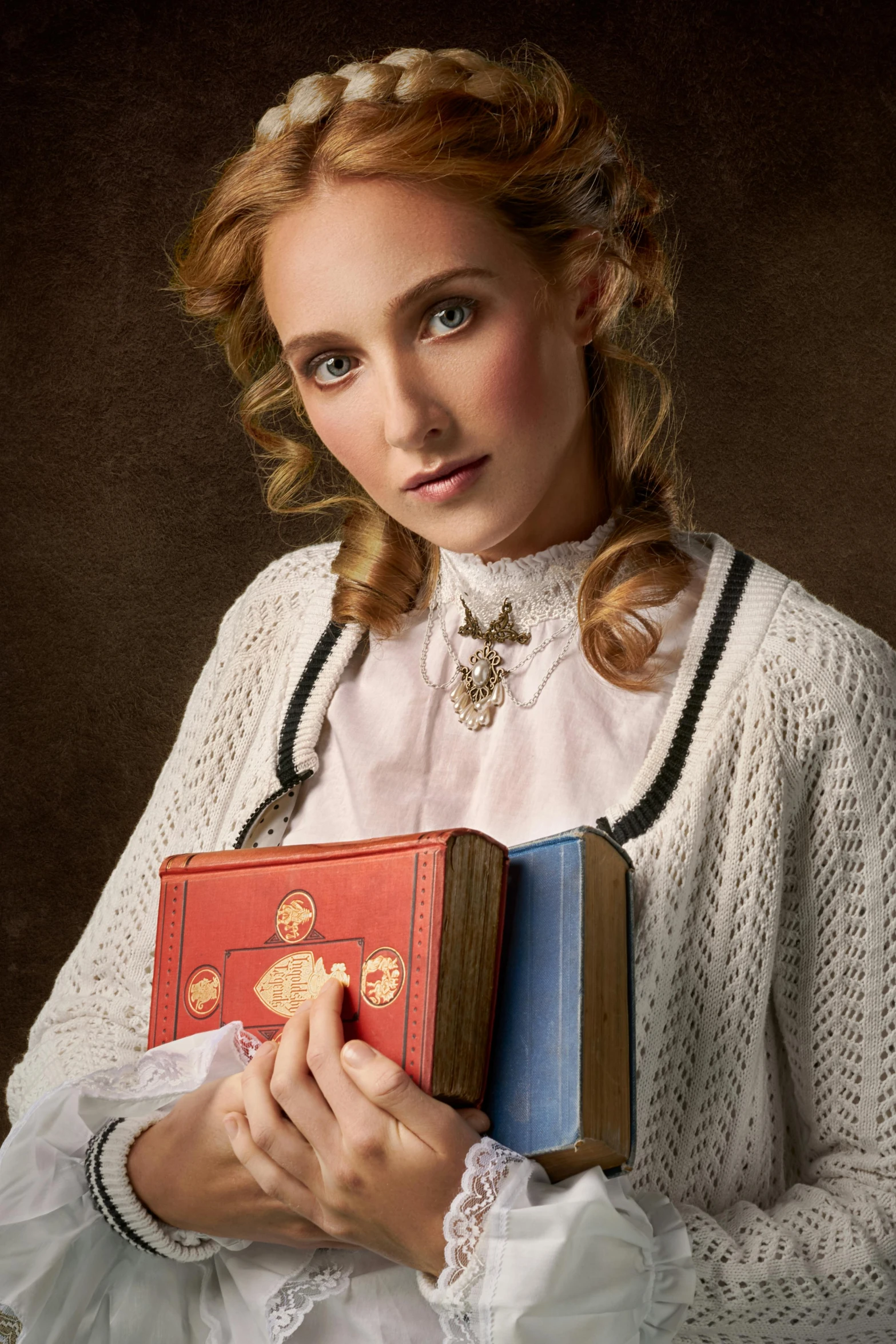 a woman is holding books with both hands