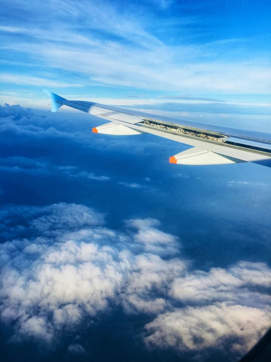 a picture taken from the airplane of the wing and the window