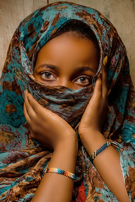 a beautiful young woman wearing a colorful scarf