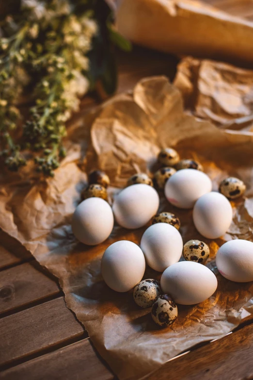 a bunch of white eggs sitting on top of paper