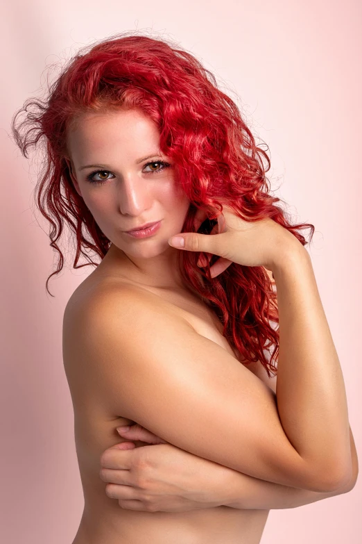 a very pretty red - haired woman posing for the camera