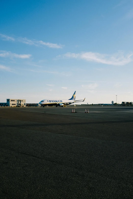 an air plane is on a runway and some buildings