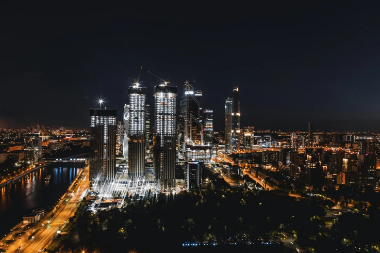 the view of the city at night from the top of the hill