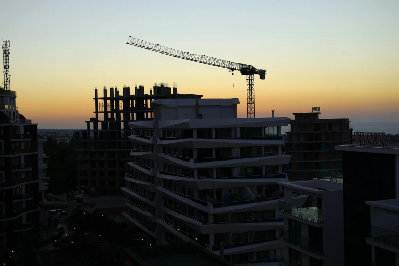 a crane is seen in the background of buildings