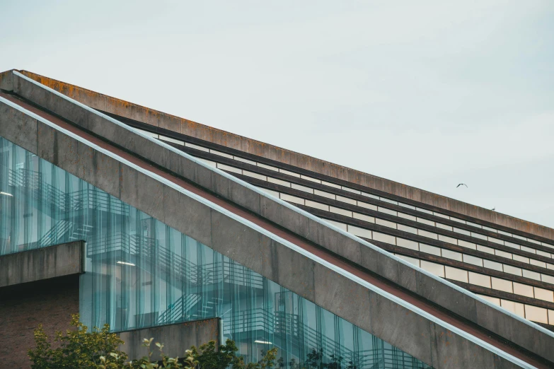 an airplane is flying by some glass windows