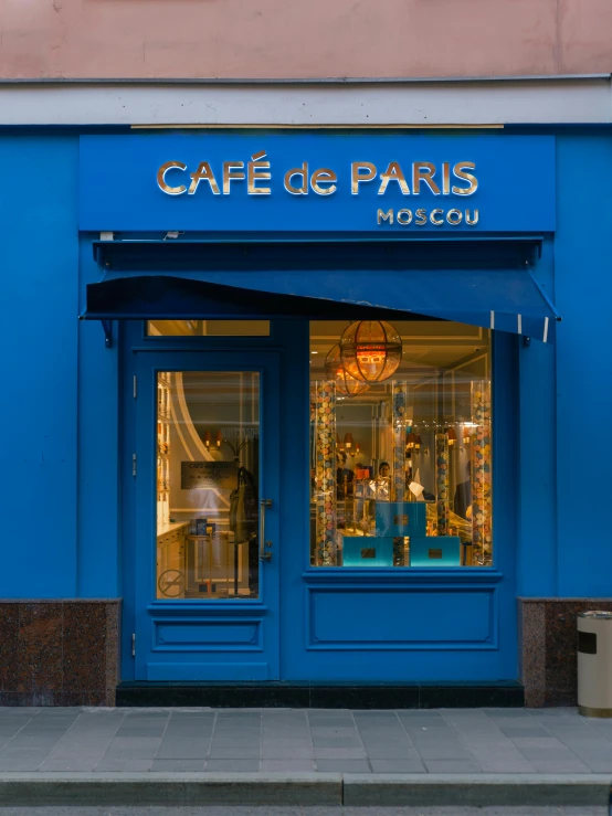 a blue store front on the side of a building