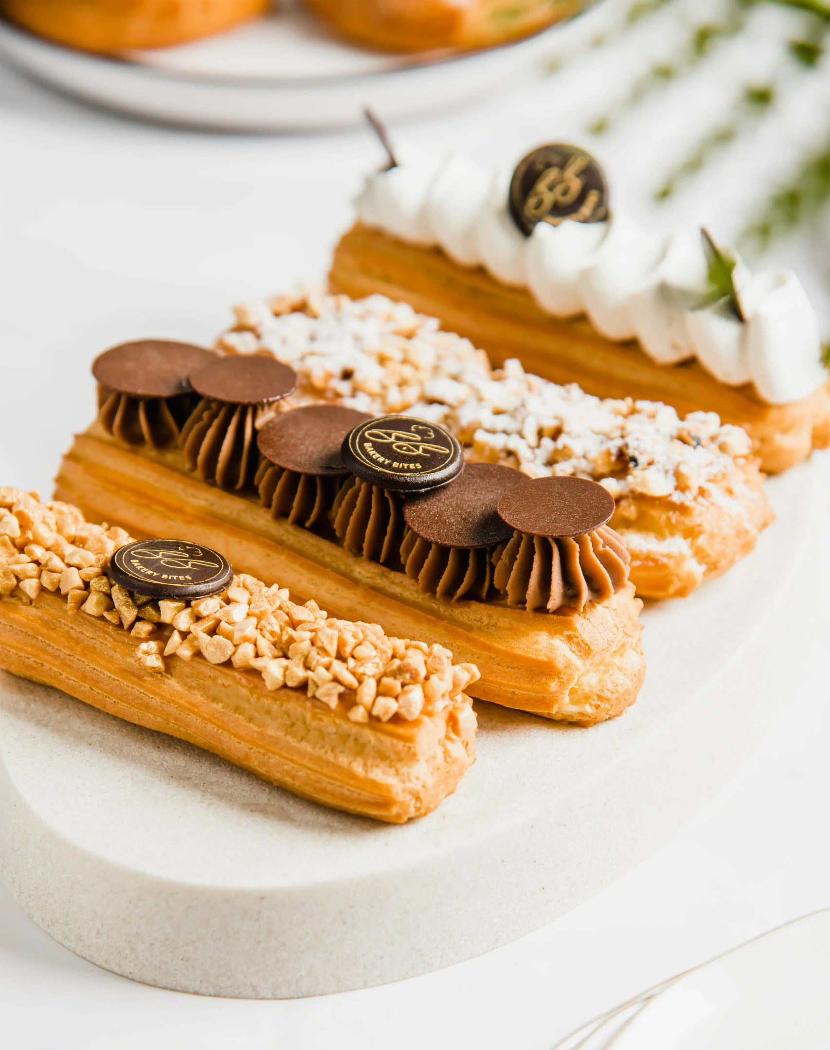 two small pastry slices covered in toppings on a white plate