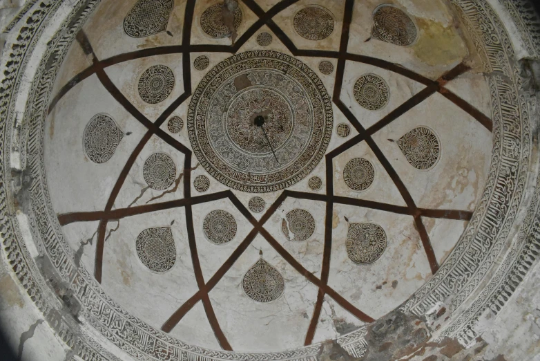 an intricate circular mural is shown on the wall