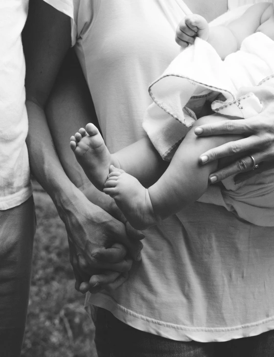 baby feet being held by a parent