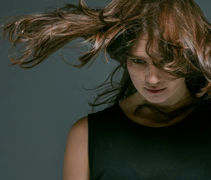 a woman with her hair blowing in the wind