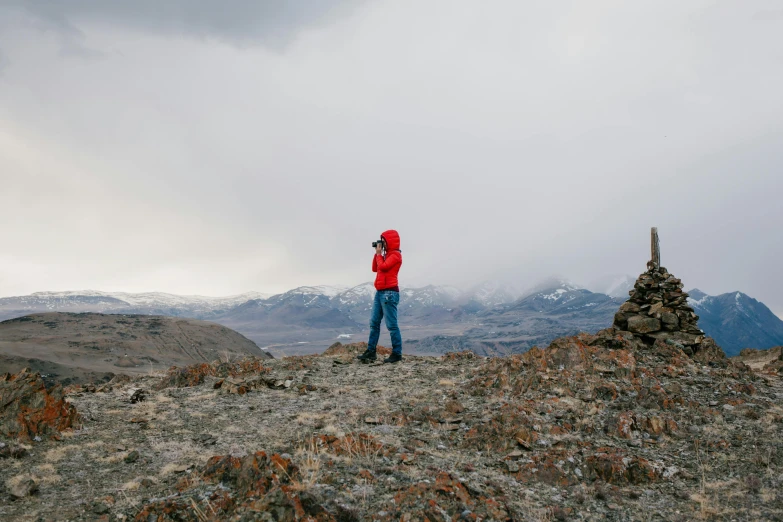 a person standing on the top of a mountain