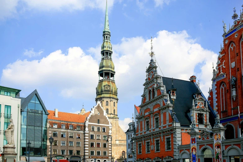 several buildings with towers are seen in a city