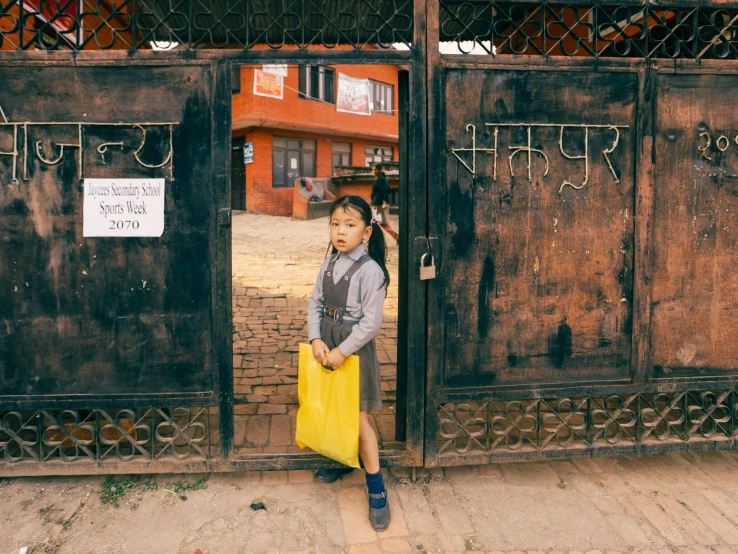 a  is standing outside a closed gate