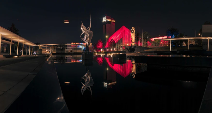 a reflection of a building and the water at night