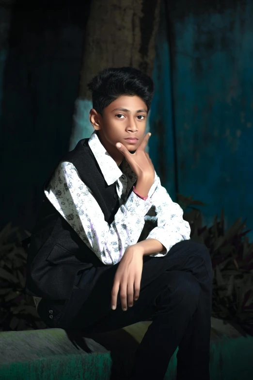 a black and white po of a boy wearing a vest