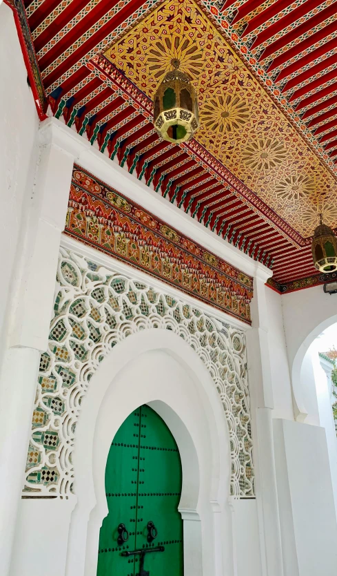 a door inside of a building with an elaborate ceiling