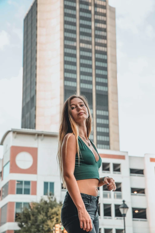 a woman standing in front of a building with a very nice look