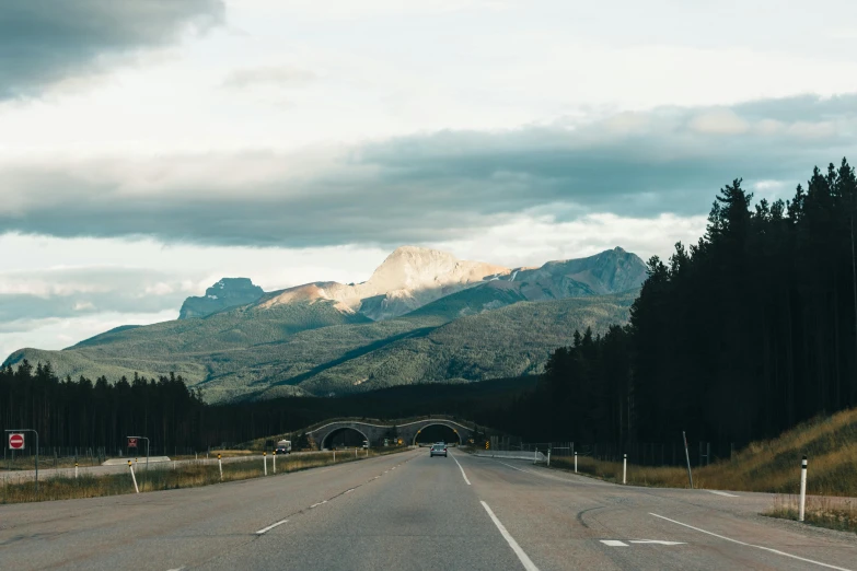 a scenic road in front of mountain range