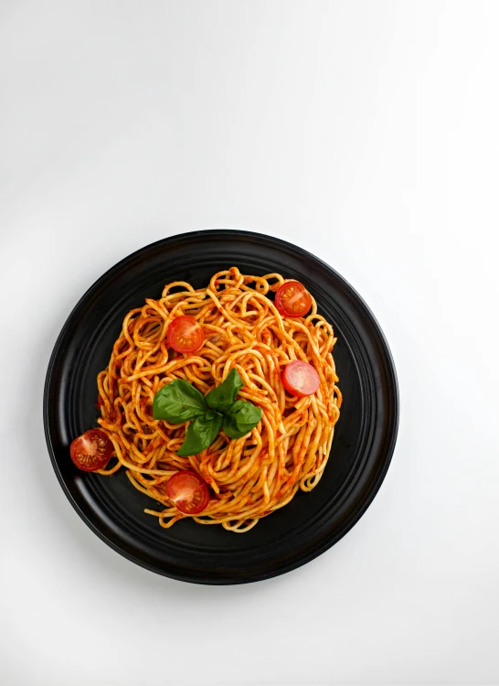 a bowl of spaghetti on a plate with a spoon