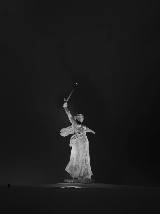 a woman dressed in white holding a sword