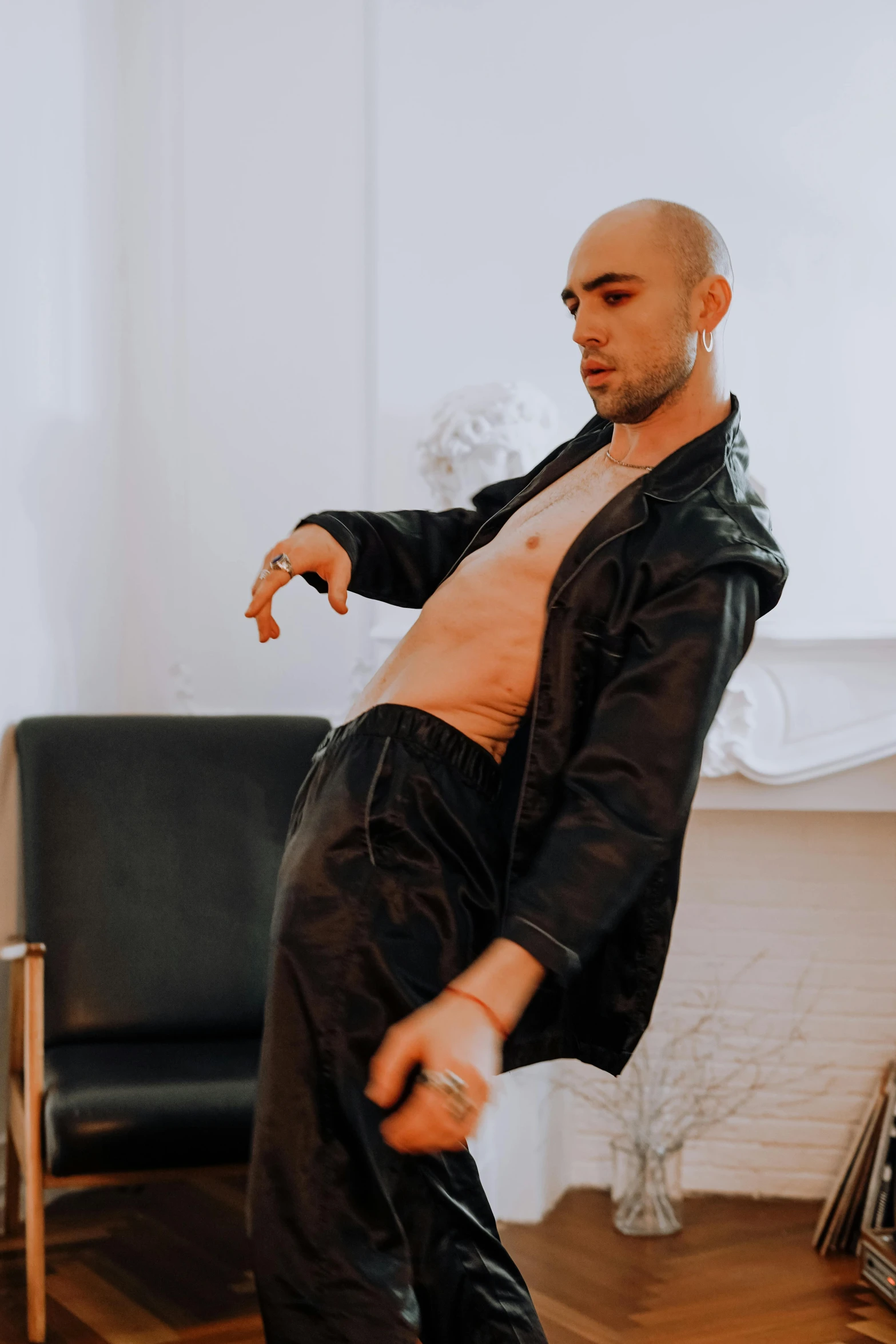 man dancing in front of couch in living room