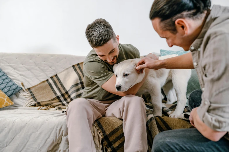 a man holding up his pet animal and giving it a bath