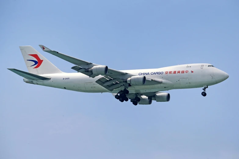 an airplane flying through the air while it's landing gear down