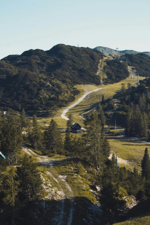 a house on top of a mountain with a ski lift behind