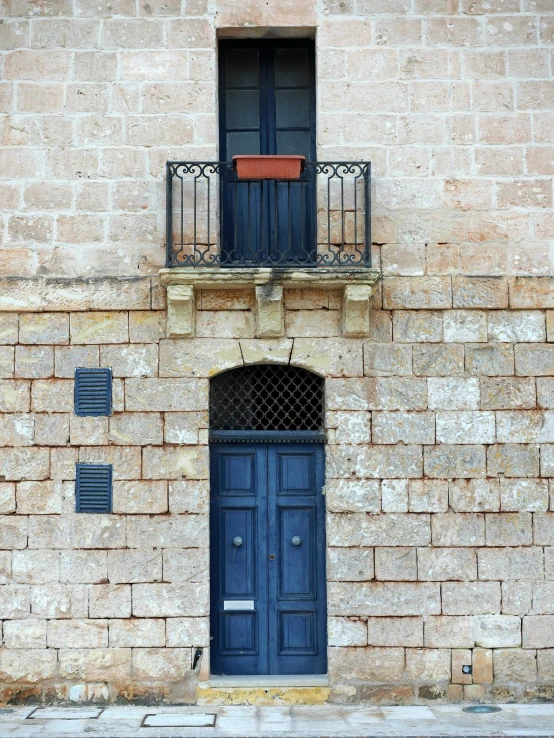 blue shutters open in an old building door