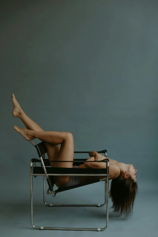 the woman is lying down on a chair