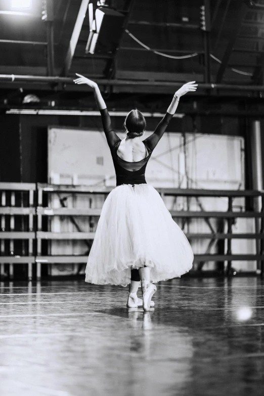 a woman that is standing in the middle of a dance floor