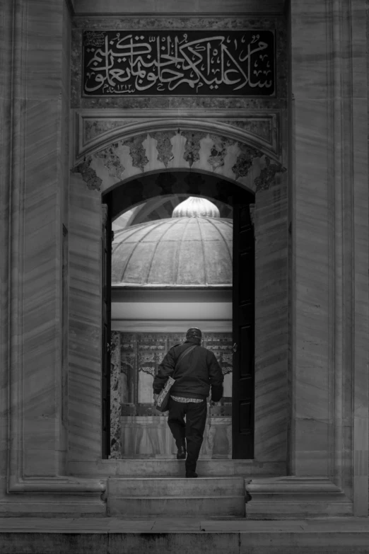 a person that is walking under a clock