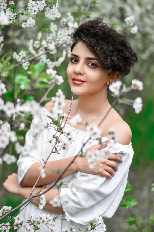 a woman poses for the camera with flowers