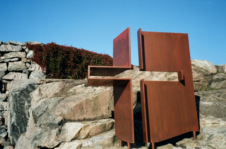 two metal doors are on some large rocks