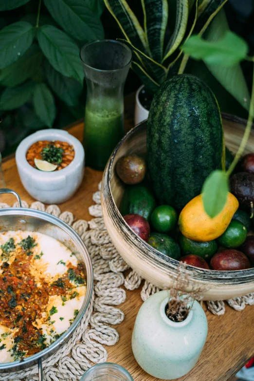 a wooden table topped with bowls of food