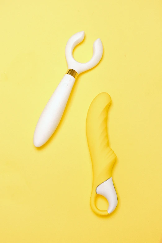 a yellow tool on a white background with one tool opened up to show its contents