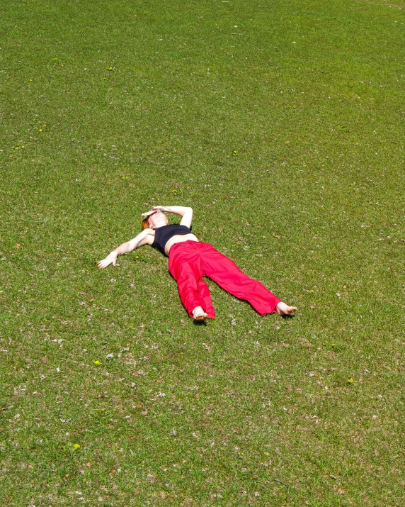 a person that is laying down in the grass