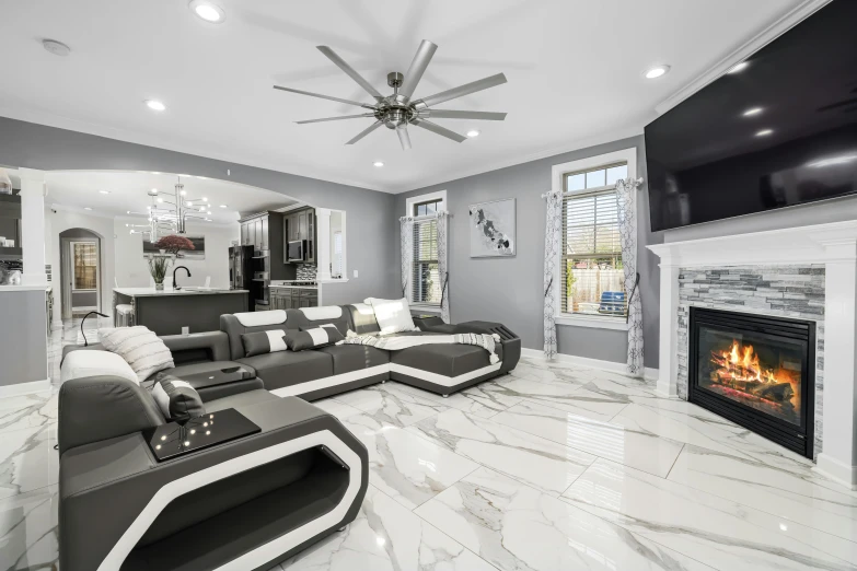 an elegant white marble living room features a large flat screen tv