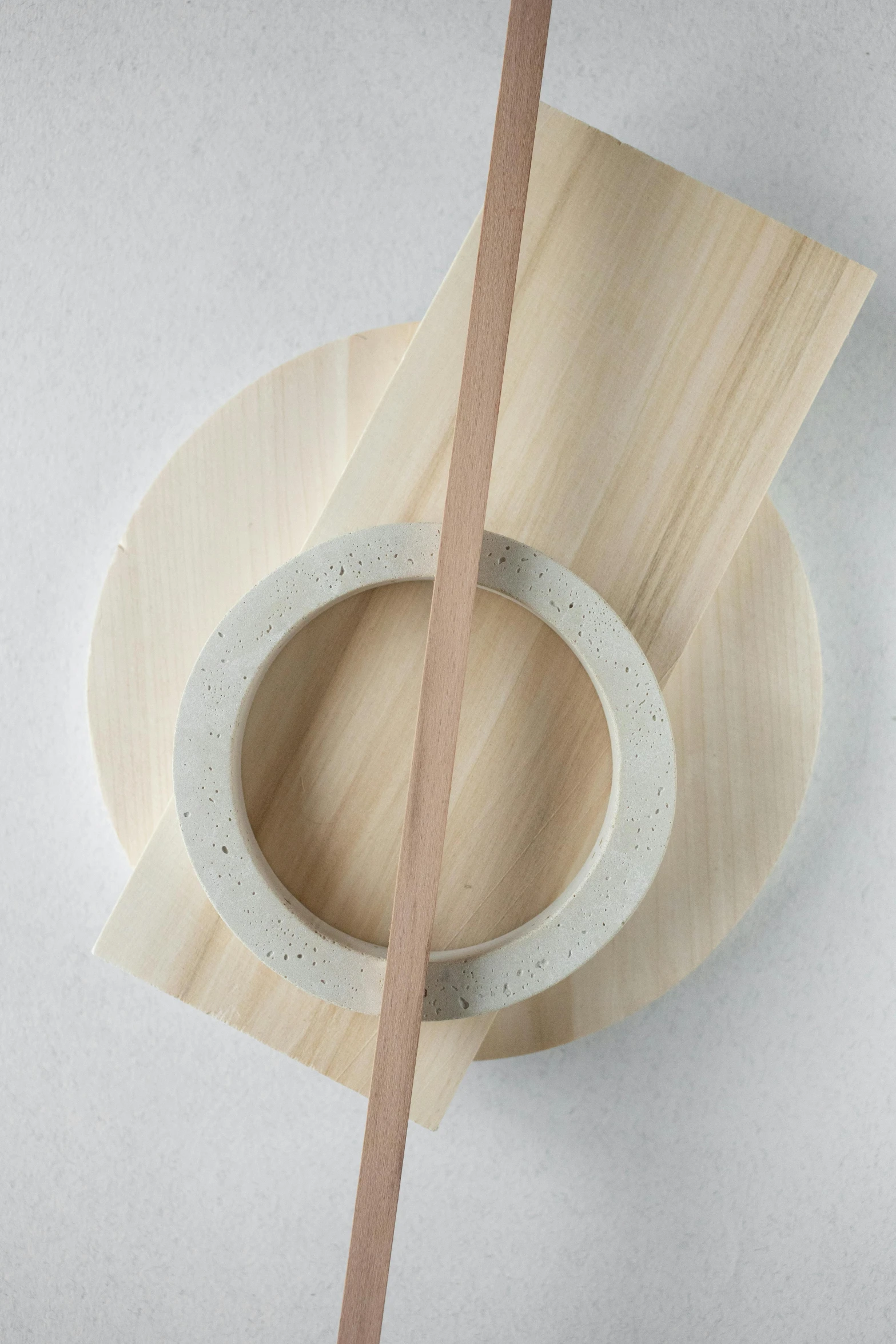 wooden circular object on white surface with one round in the middle